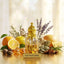 Gold perfume bottle labeled 'Sauvage Dior' surrounded by fruits, flowers, and herbs on a light background.