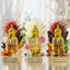 Three gold perfume bottles labeled 'Oud Saffron', 'White Oud', and 'Ameer Ul Oud' with floral and spice decorations on a reflective surface.