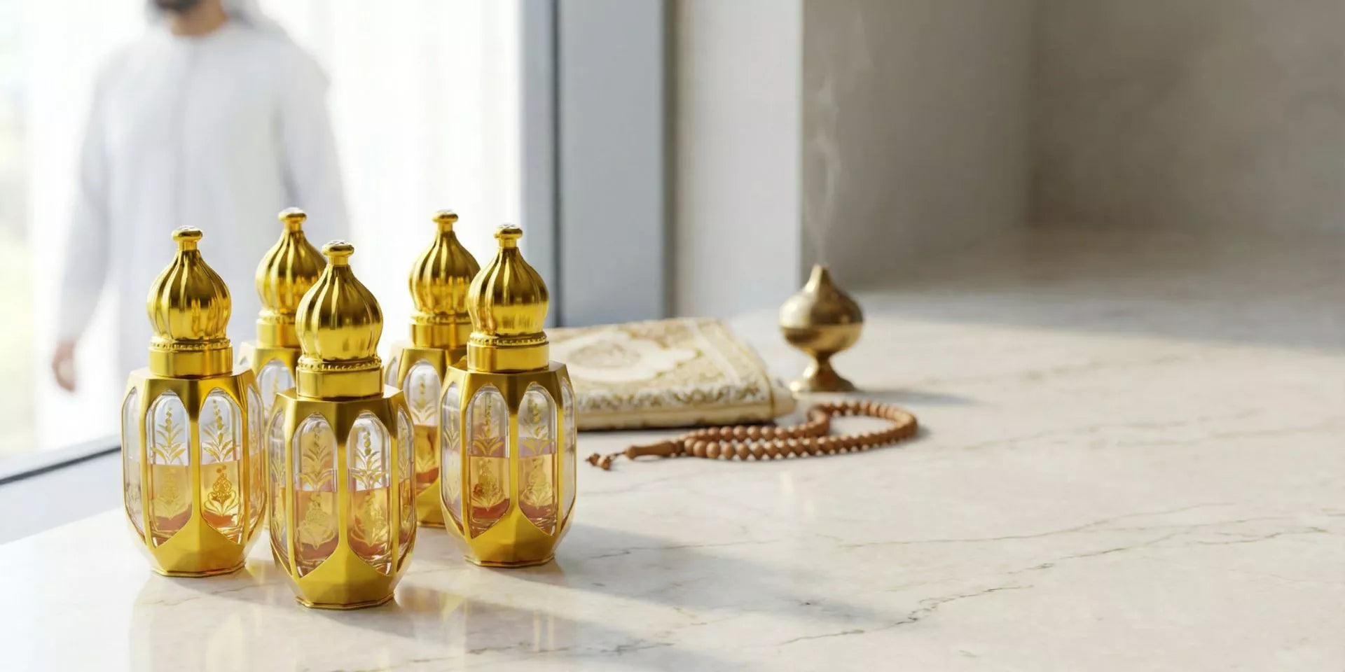 Gold perfume bottles on a light wooden surface with a blurred person in the background