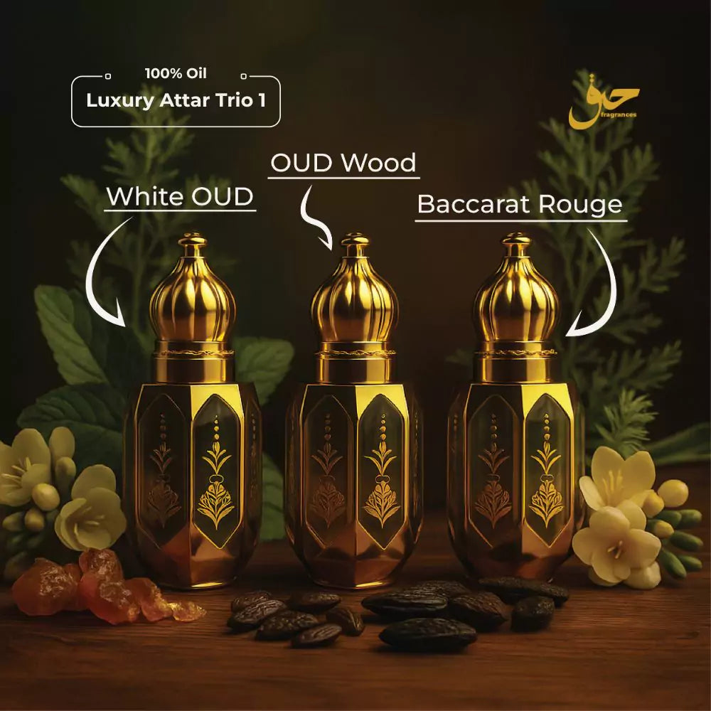 Three gold attar bottles labeled 'White OUD', 'OUD Wood', and 'Baccarat Rouge' with floral and fruit decorations on a dark background. - Haq Fragrances