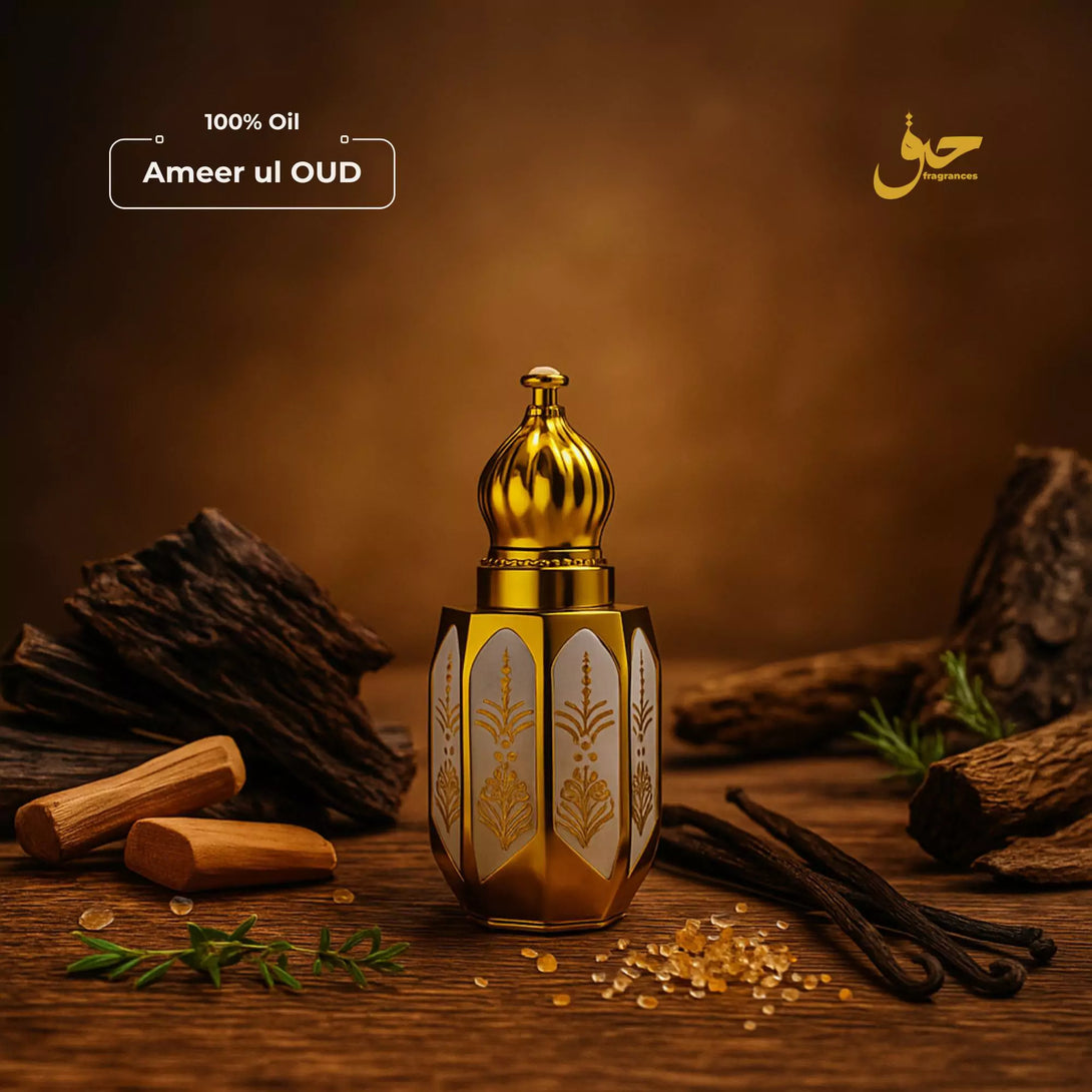 Ameer ul Oud attar bottle with gold cap on a wooden surface with spices and herbs. - Haq Fragrances
