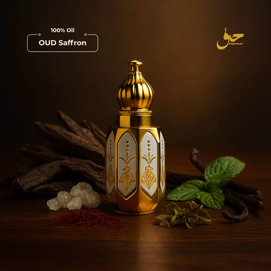 Gold bottle of Oud Saffron oil with saffron and mint leaves on a dark background - Haq Fragrances