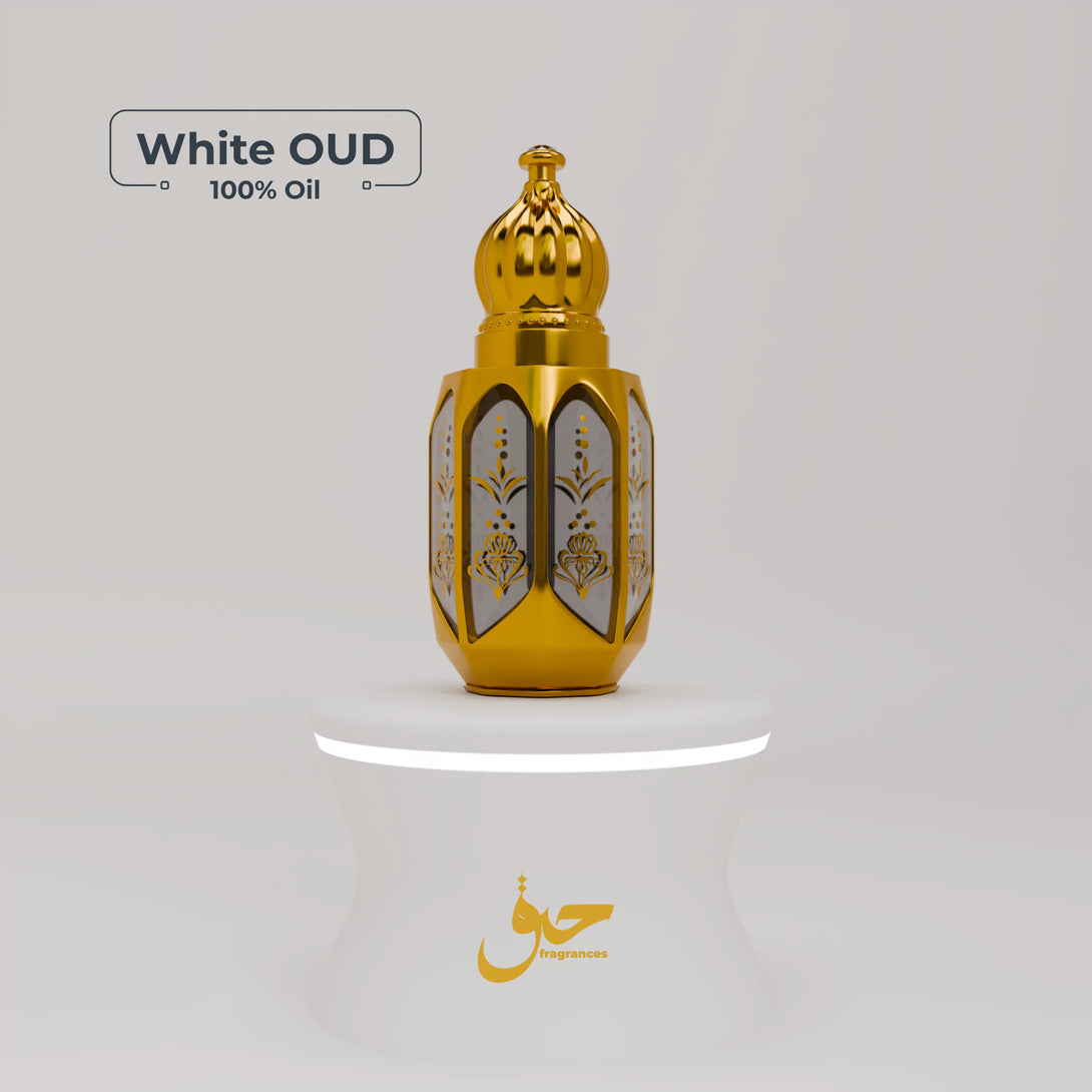 Photo of White OUD perfume oil in a gilded glass bottle on rocky terrain, an exotic and smooth Arabian fragrance ideal for those looking to buy a creamy, long-lasting OUD scent.